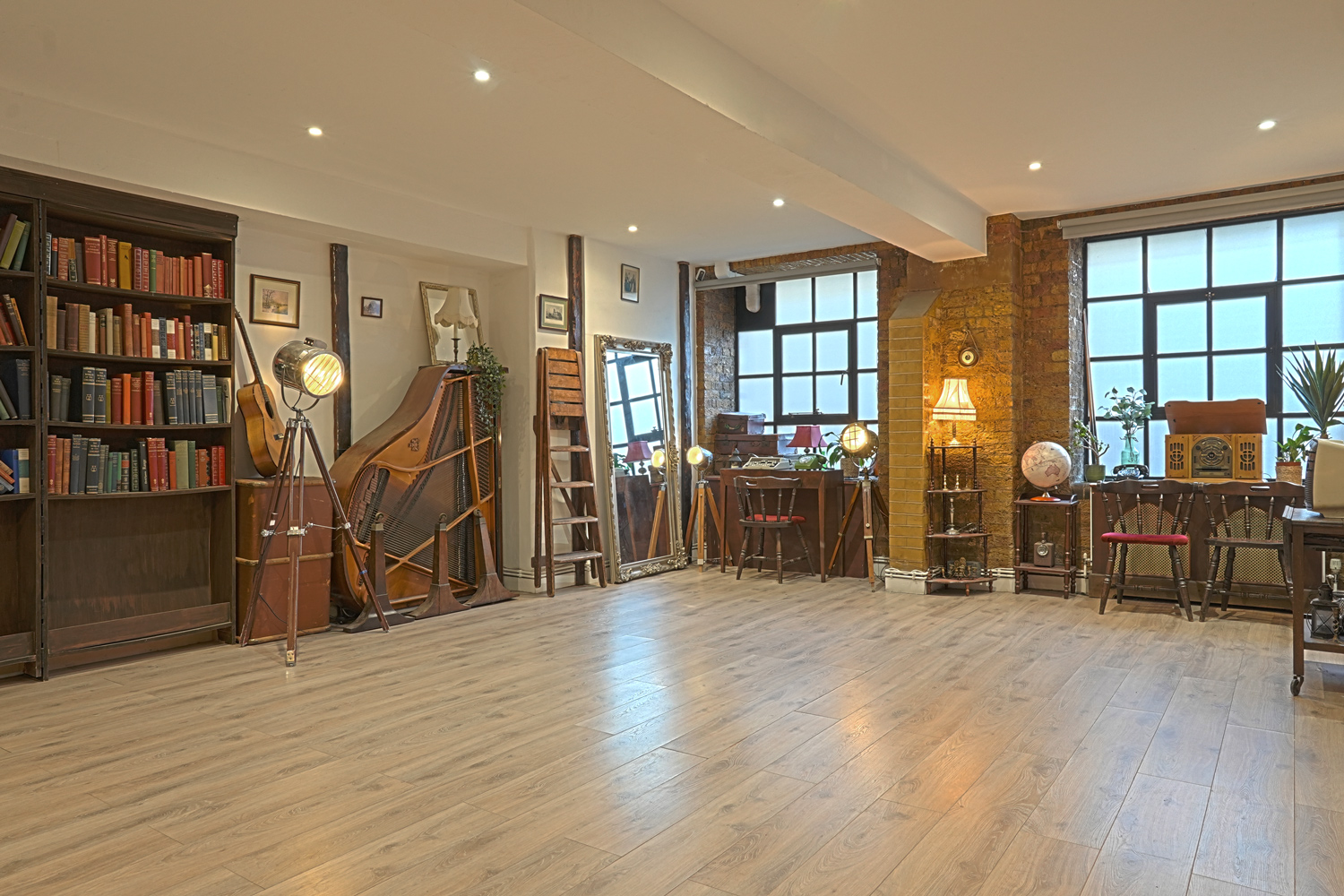Interior of GOOT Studio, a warehouse-conversion photo and video studio with exposed brick and industrial lighting
